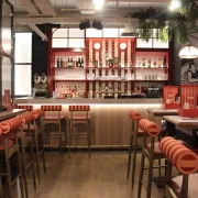 Stylish interiors of Landy’s new restaurant on the Royal Mile in Edinburgh, 2024, showcasing nautical decor with ropes, anchors, and rich navy and red tones.