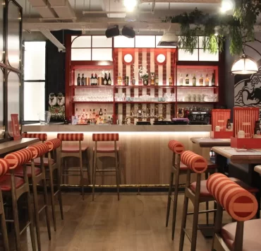Stylish interiors of Landy’s new restaurant on the Royal Mile in Edinburgh, 2024, showcasing nautical decor with ropes, anchors, and rich navy and red tones.