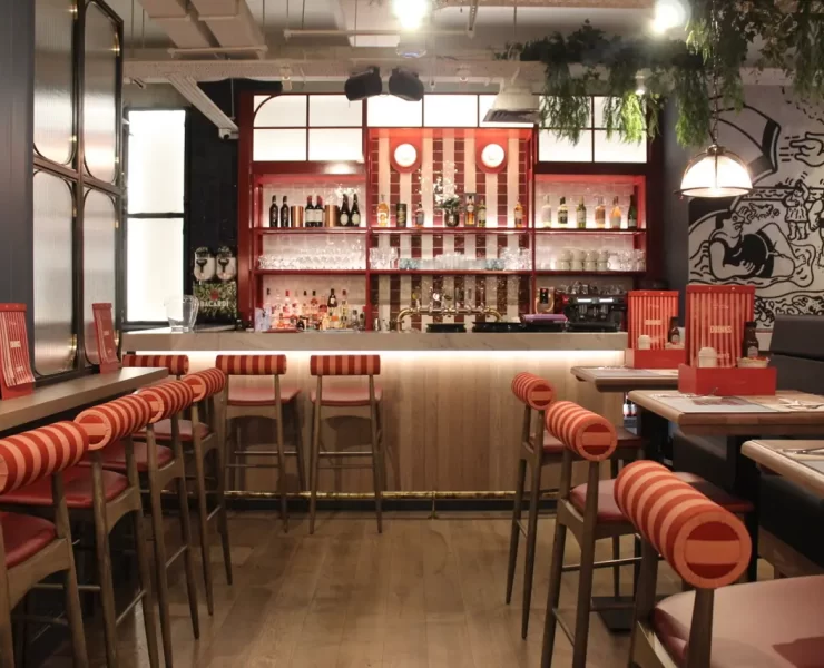 Stylish interiors of Landy’s new restaurant on the Royal Mile in Edinburgh, 2024, showcasing nautical decor with ropes, anchors, and rich navy and red tones.