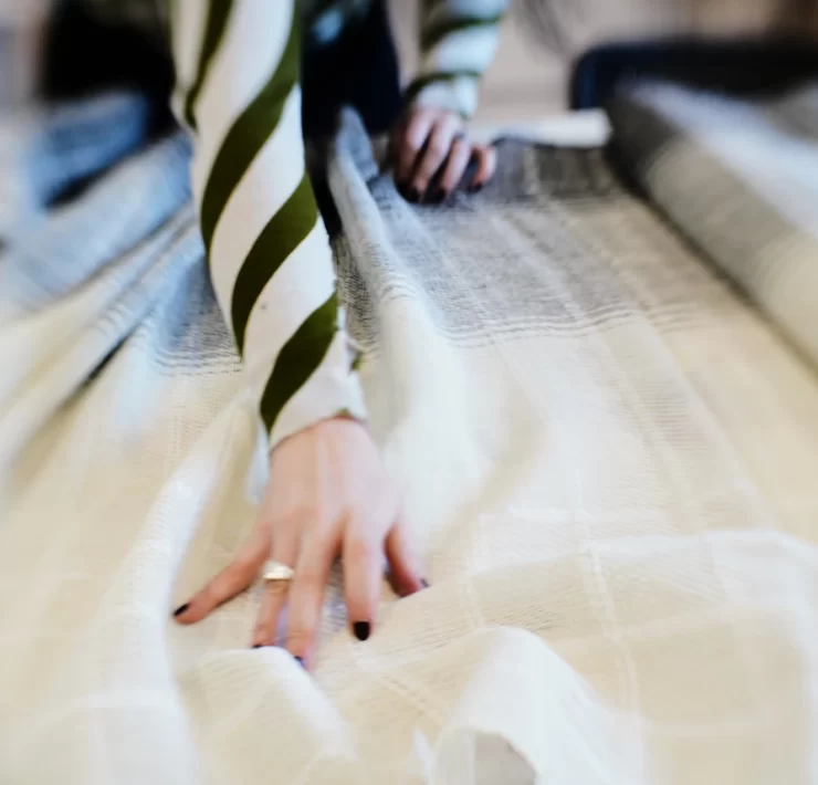 Close-up of hand dyeing a length of woven fabric