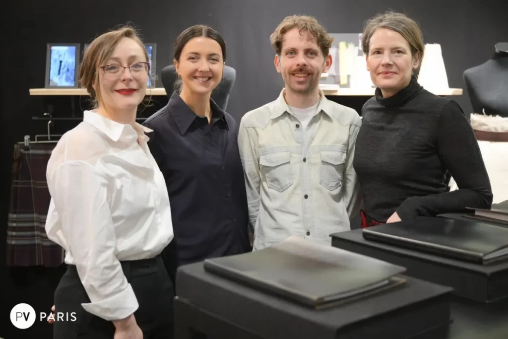 Group photo of Scottish textile designers standing together at their exhibition booth