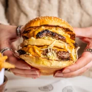 Close-up of The Big Matt burger at Hawksmoor Edinburgh: a double patty burger with melted American cheese, shredded lettuce, onions and special sauce, served with beef dripping fries — a popular lunch option in Edinburgh.