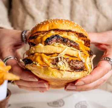 Close-up of The Big Matt burger at Hawksmoor Edinburgh: a double patty burger with melted American cheese, shredded lettuce, onions and special sauce, served with beef dripping fries — a popular lunch option in Edinburgh.