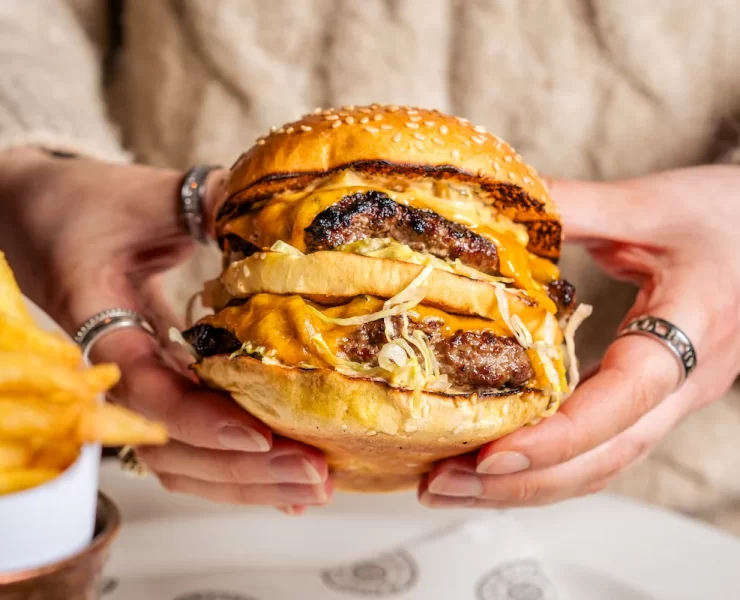 Close-up of The Big Matt burger at Hawksmoor Edinburgh: a double patty burger with melted American cheese, shredded lettuce, onions and special sauce, served with beef dripping fries — a popular lunch option in Edinburgh.
