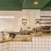 White tiled counter with brass trim at Pantry Bruntsfield