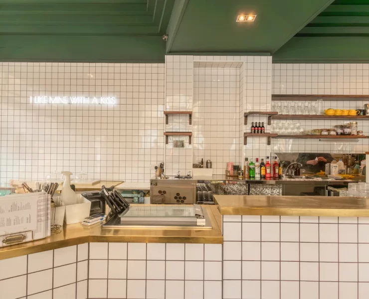 White tiled counter with brass trim at Pantry Bruntsfield
