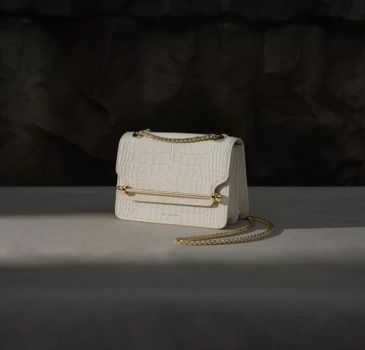 White croc-embossed Strathberry handbag with gold chain strap, part of the 2025 Edinburgh sample sale selection.