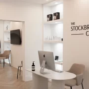 Modern reception area at The Stockbridge Clinic in Edinburgh, featuring minimalist white interiors and soft neutral furnishings