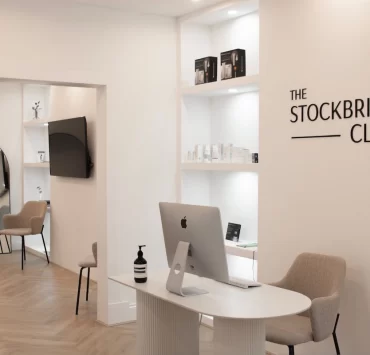Modern reception area at The Stockbridge Clinic in Edinburgh, featuring minimalist white interiors and soft neutral furnishings
