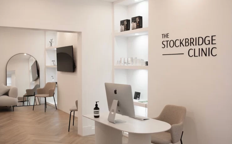 Modern reception area at The Stockbridge Clinic in Edinburgh, featuring minimalist white interiors and soft neutral furnishings