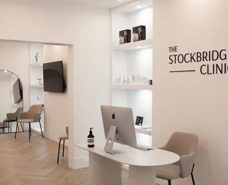 Modern reception area at The Stockbridge Clinic in Edinburgh, featuring minimalist white interiors and soft neutral furnishings