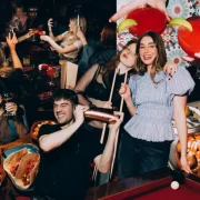 A group of young people enjoying cocktails, Spanish tapas, and socialising at Rioja Glasgow during a lively supper club event.