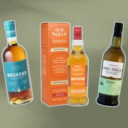 Bottles of Bruadar, Old Perth Amontillado, and Mac-Talla Terra whisky on green background