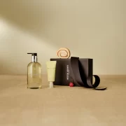 A Molton Brown gift set with hand wash, lotion, and gift box on a neutral background.
