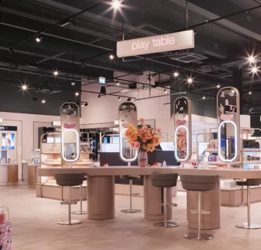 Interactive beauty play table at H beauty Silverburn, showcasing makeup and skincare zones under soft lighting