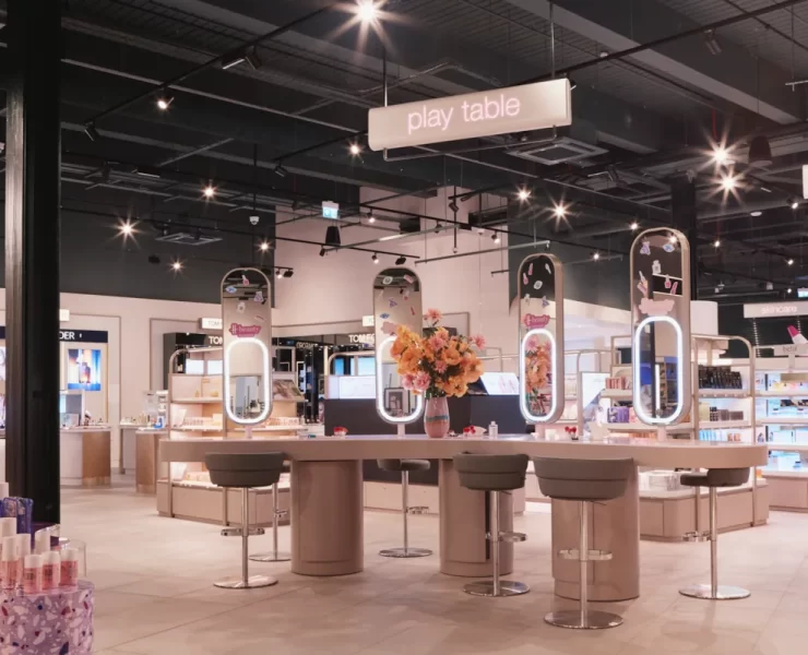 Interactive beauty play table at H beauty Silverburn, showcasing makeup and skincare zones under soft lighting