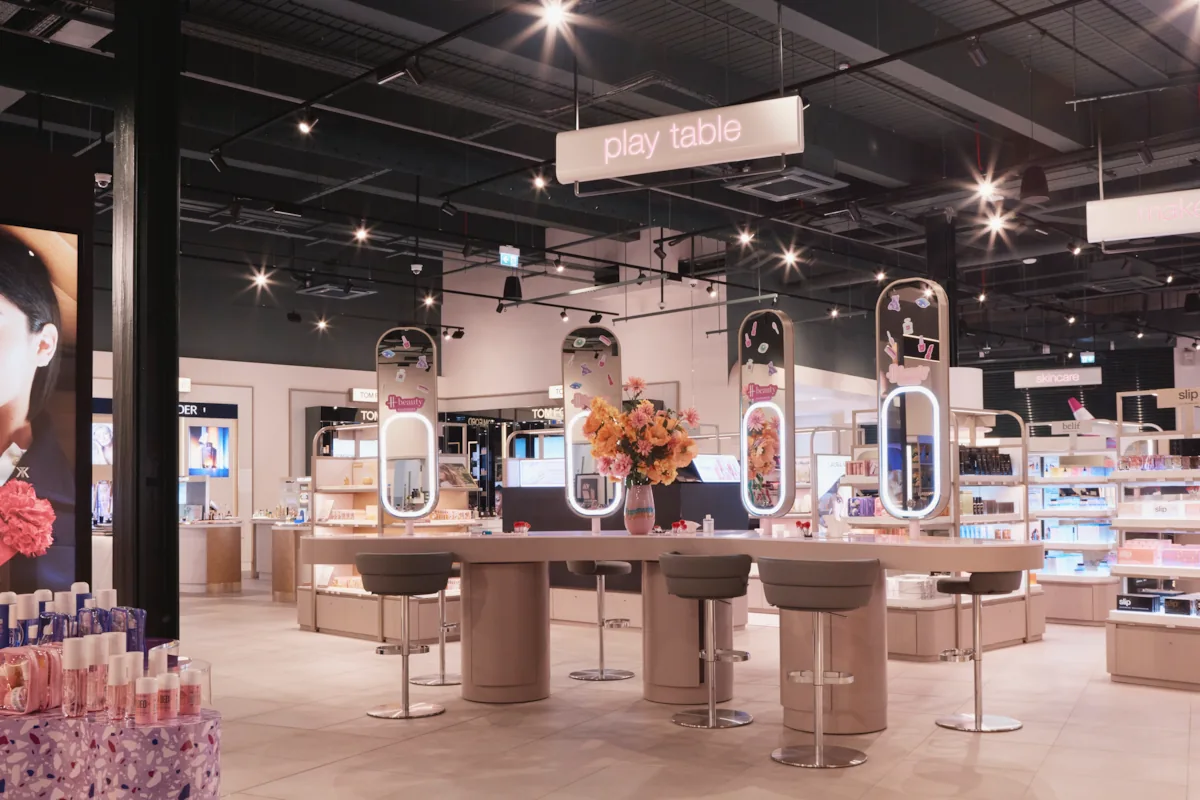 Interactive beauty play table at H beauty Silverburn, showcasing makeup and skincare zones under soft lighting