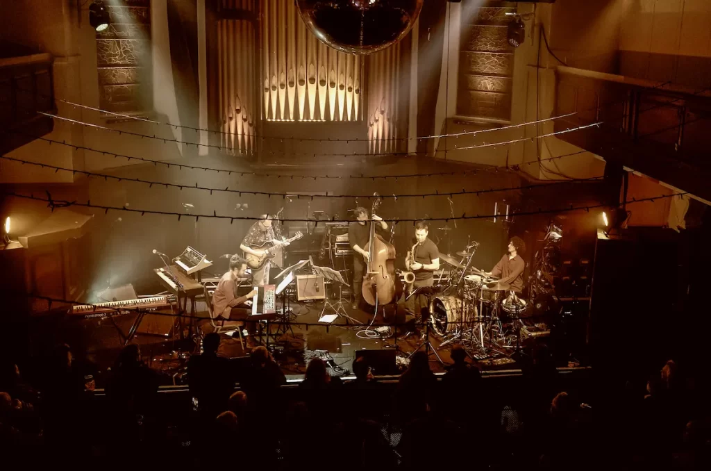 Modern Vikings performing under stage lights with double bass and drums