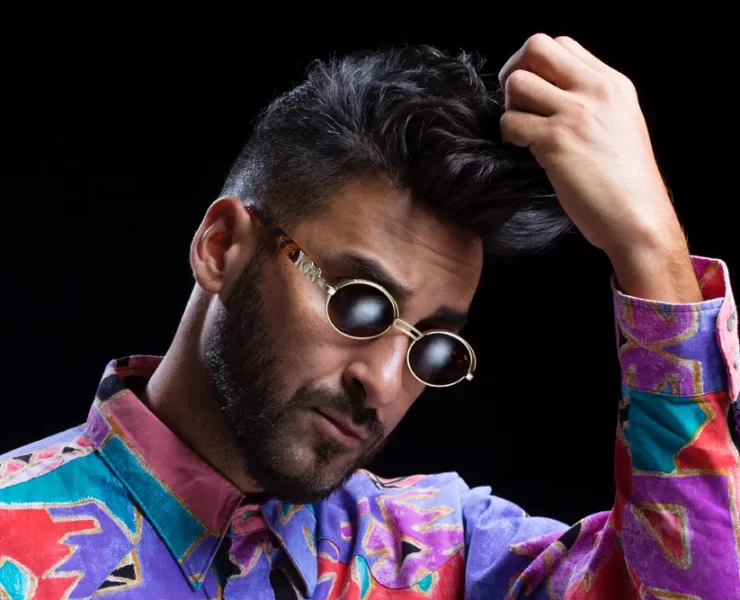 Armand Van Helden wearing sunglasses and a colourful shirt ahead of his Scottish headline set at Hopetoun House Sessions 2025.