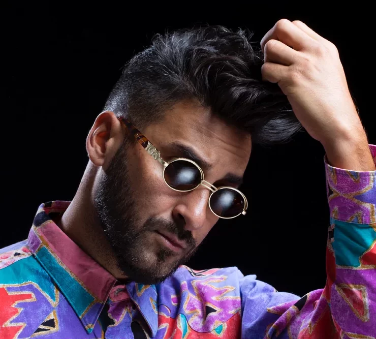 Armand Van Helden wearing sunglasses and a colourful shirt ahead of his Scottish headline set at Hopetoun House Sessions 2025.
