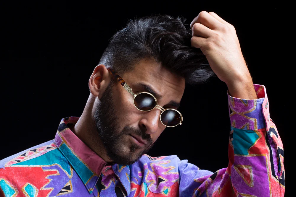 Armand Van Helden wearing sunglasses and a colourful shirt ahead of his Scottish headline set at Hopetoun House Sessions 2025.