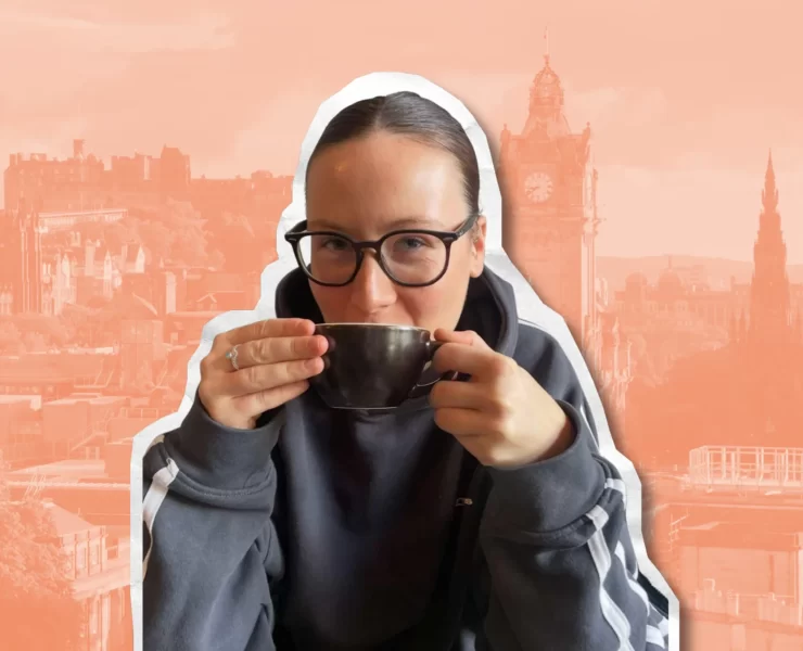 Amyricano TikTok creator holding a coffee cup with Edinburgh skyline in the background