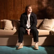 Lewis Capaldi talks about growing up in Whitburn, West Lothian whilst wearing HEYDUDE shoes while sitting on a sofa for the Country campaign