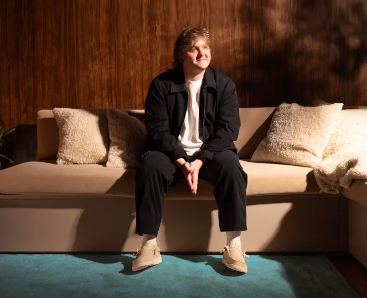 Lewis Capaldi talks about growing up in Whitburn, West Lothian whilst wearing HEYDUDE shoes while sitting on a sofa for the Country campaign