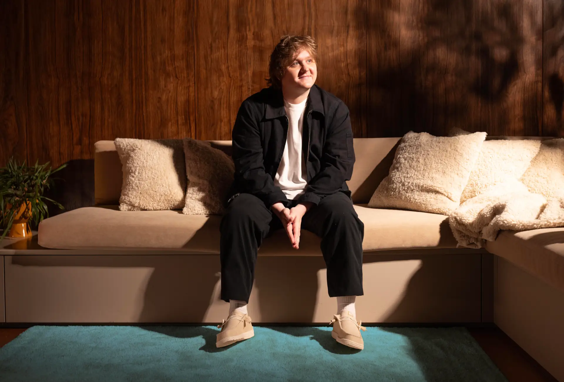 Lewis Capaldi talks about growing up in Whitburn, West Lothian whilst wearing HEYDUDE shoes while sitting on a sofa for the Country campaign