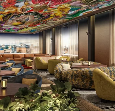 Indoor rooftop lounge with city views at SíSí Glasgow, featuring patterned sofas and soft lighting