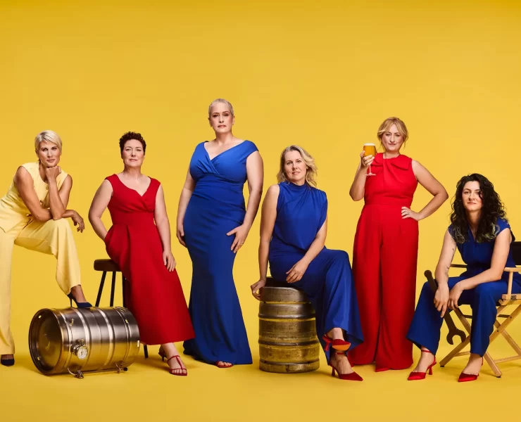 Six women brewers from Scotland pose in bold red, blue and yellow outfits with beer barrels and glasses, marking Lidl’s gender-balanced beer aisle initiative.
