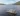 Overhead view of the Taymouth Marina HotBoat floating sauna with guests swimming in Loch Tay, surrounded by rolling hills and open water.