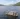 Overhead view of the Taymouth Marina HotBoat floating sauna with guests swimming in Loch Tay, surrounded by rolling hills and open water.
