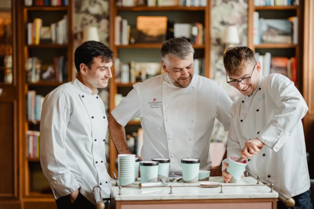 Three chefs in white jackets preparing gelato together at The Balmoral’s Bar Prince.