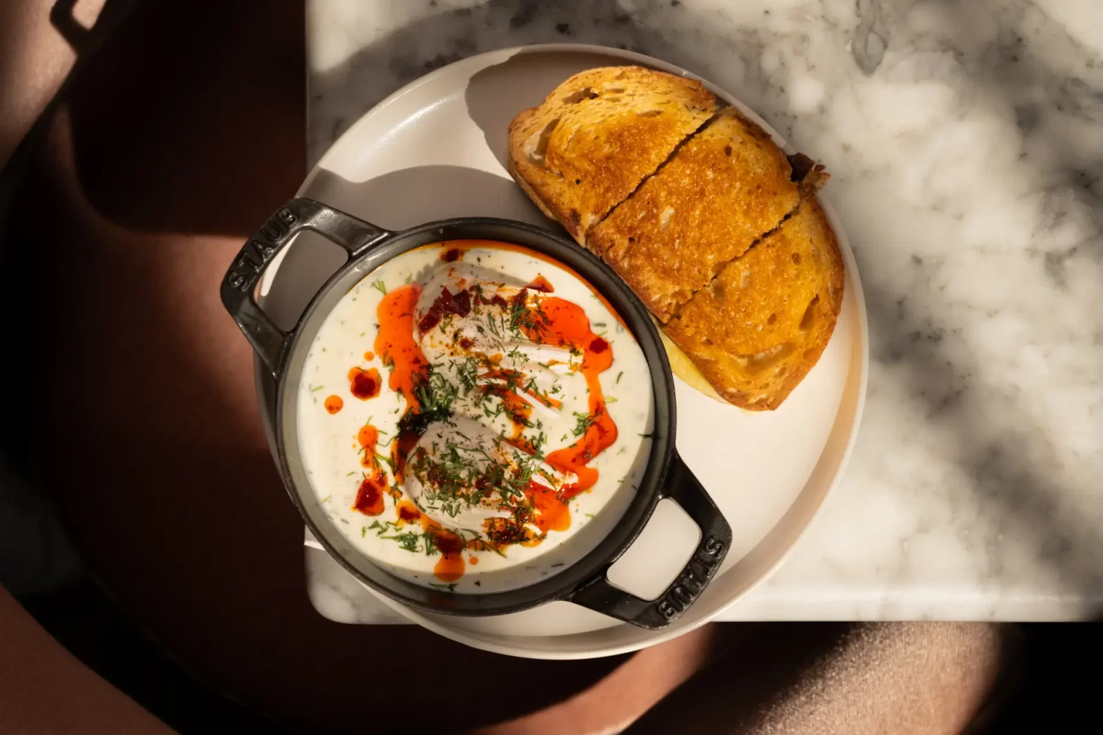 Eggbreak’s rich and creamy Turkish Eggs served in a cast iron dish with dill yoghurt, smoked paprika oil, and a side of golden toasted bread. This brunch classic is one of the signature dishes available during the brand’s Edinburgh residency.