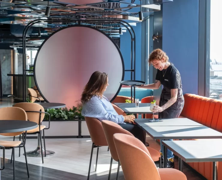 A bartender serves a cocktail to a guest at VEGA Glasgow, the city centre rooftop bar with panoramic views and Glasgow’s first customisable cocktail night out.