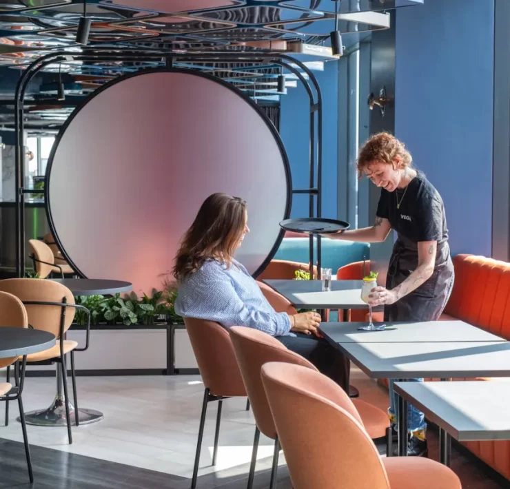 A bartender serves a cocktail to a guest at VEGA Glasgow, the city centre rooftop bar with panoramic views and Glasgow’s first customisable cocktail night out.