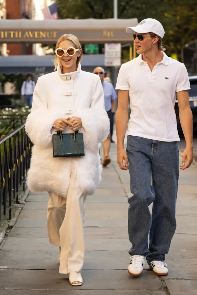 Kelly Rutherford and son Hermés Giersch walking together in New York, she is carrying the Strathberry Mini Tote.