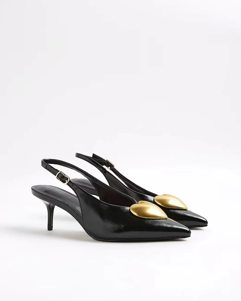 Black slingback kitten heels from River Island with pointed toes and oversized gold heart detailing.