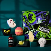 Lush Countdown to Halloween advent calendar box with seven products – including ghost and skeleton bath bombs, Pumpkin Spice Latte shower gel and spooky soap – displayed against a dark teal background.