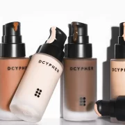 DCYPHER Beauty custom foundation bottles in multiple skin tones with pump applicators.