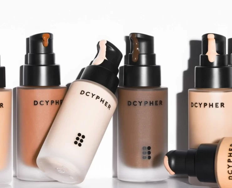 DCYPHER Beauty custom foundation bottles in multiple skin tones with pump applicators.