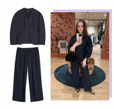 River Island navy pinstripe cocoon-sleeve blazer and matching low-waist trousers styled with pointed heels and a black feather bag, perfect for autumn layering.