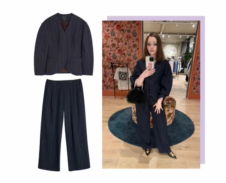 River Island navy pinstripe cocoon-sleeve blazer and matching low-waist trousers styled with pointed heels and a black feather bag, perfect for autumn layering.