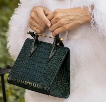 Close-up of the Strathberry Mini Tote bag in green embossed croc leather with gold bar.