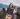 Woman wearing a colourful Columbia fleece outdoors on a mountain bridge, showcasing the brand’s performance outerwear collection.