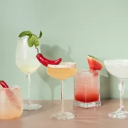Selection of colourful cocktails with chilli and watermelon garnishes at The Delphine cocktail bar in Glasgow.
