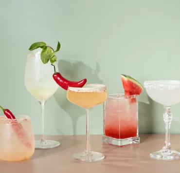 Selection of colourful cocktails with chilli and watermelon garnishes at The Delphine cocktail bar in Glasgow.
