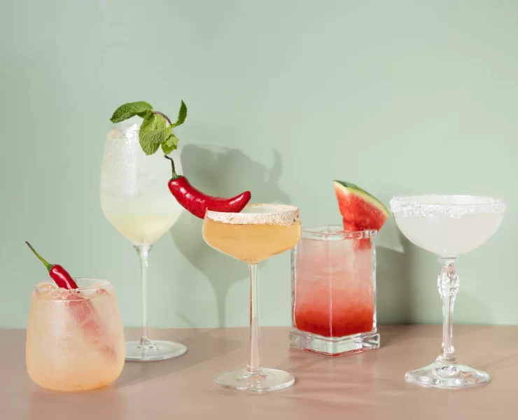 Selection of colourful cocktails with chilli and watermelon garnishes at The Delphine cocktail bar in Glasgow.