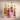 Four glass bottles of Highland Boundary Wild Botanical Syrups in vibrant packaging — Gorse, Honeysuckle, Scots Pine and Rosebay — photographed against a soft neutral background.